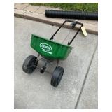 Scotts fertilizer spreader folded up easy storage.