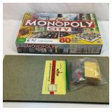 Monopoly City and old Monopoly board with pieces