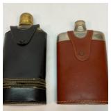 Two older glass flasks with leather cases