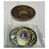 Two belt buckles. New Lions Club and KC train