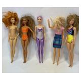 Five Barbie dolls