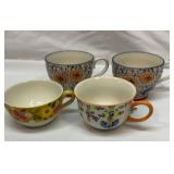 Four hand-painted ceramic mugs. Various makers