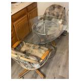 Glass top table and two chairs on wheels