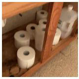 Contents of vanity in bathroom.  Toilet paper, etc