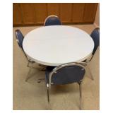 White oval table with four chairs