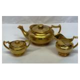 Gold lustre tea pot, sugar and creamer