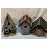 Two old wood bird houses and a feeder