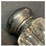 Four salt and peppers with sterling silver tops