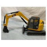 CAT backhoe. Roughly 18 inches long.