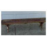 Red painted wood picnic bench.  70 inches long