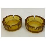 Two amber ashtrays. 4 inches wide.