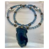 Translucent blue agate slice necklace in case