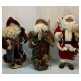 Three Santa figures