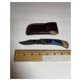 Ornate Damascus-Pattern Folding Knife  Blue Hands
