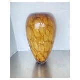 Contemporary amber-toned art glass vase featuring.