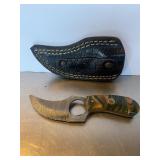 Custom Damascus steel skinning knife with a swirl.