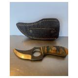 Custom fixed-blade skinner knife with a finger ho.