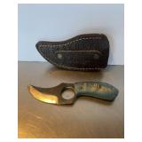 Custom skinning knife featuring a blue swirl comp.