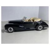 Vintage die-cast model of a black Mercedes-Benz c.