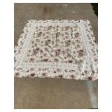 Vintage floral printed quilt with scalloped edges.