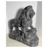 Cast metal or resin statue of a standing lion wit.