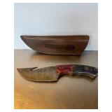 Custom Damascus steel skinning knife with a gut h.