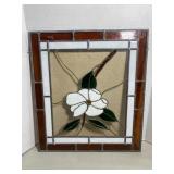 Stained glass panel featuring a central white dog.