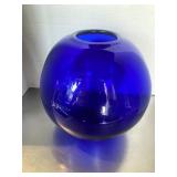 Large round cobalt blue glass sphere vase featuri.