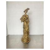 Gold-painted metal figurine of a Gibson Girl-styl.