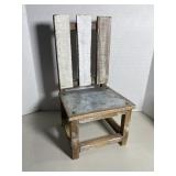 Rustic miniature chair crafted from weathered pal.