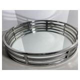 Contemporary round vanity tray featuring a reflec.