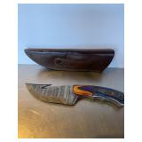 Custom Damascus steel skinning knife with a gut h.