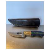 Custom fixed-blade knife featuring a bear silhoue.