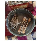 Tin of spoons and walnut tools