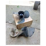 Two boat propellers and anchor weight