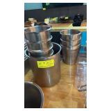 Nine assorted size round stainless steel inserts
