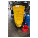 Five Yellow 5 gallon food storage buckets with