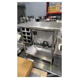 Stainless steel work table with rolled edges and