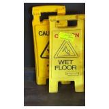 Two wet floor signs