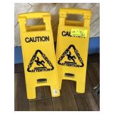 Two wet floor signs