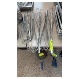 Six large stainless steel whips