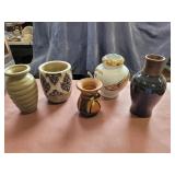 Assorted clay and ceramic vases.