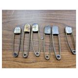 Large brass safty pins. From a laundry service