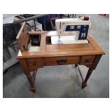 Singer sewing machine in wood cabinet. Works