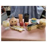 Assorted candles and candle holders.