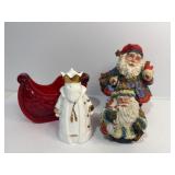 Various Santaï¿½s and red plastic sleigh