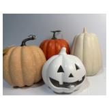 Two plastic and two ceramic pumpkins