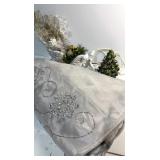 Tree skirt, white sleigh and small ceramic tree
