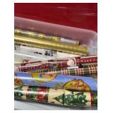 Various rolls of wrapping paper and bin with lid