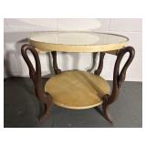 Vintage Empire-style round accent table featuring